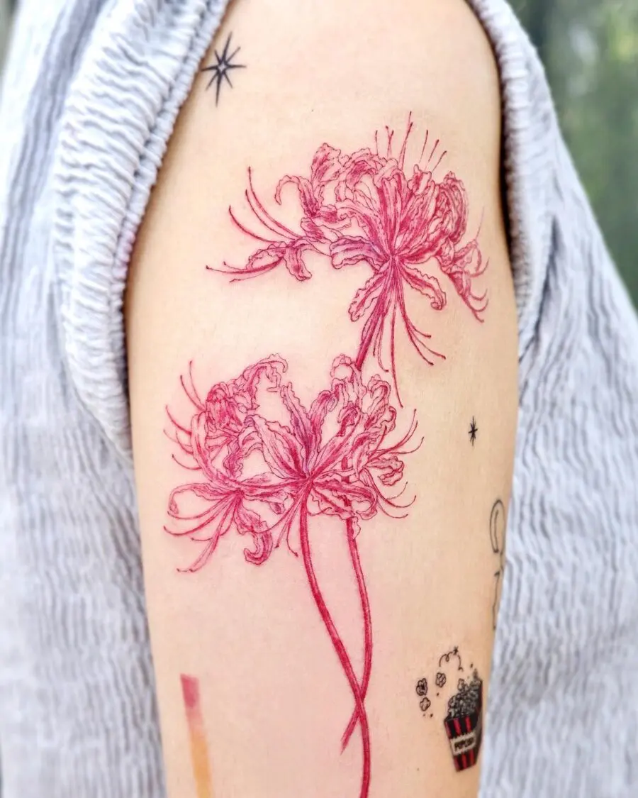 Elegant red ink floral tattoo on arm