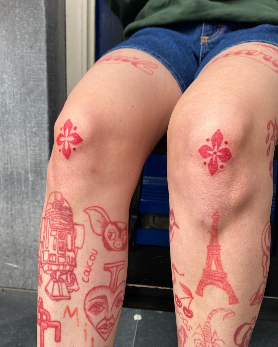 Vibrant red ink tattoo designs on legs
