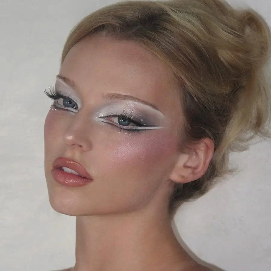 Bold silver eye look with soft glamour.