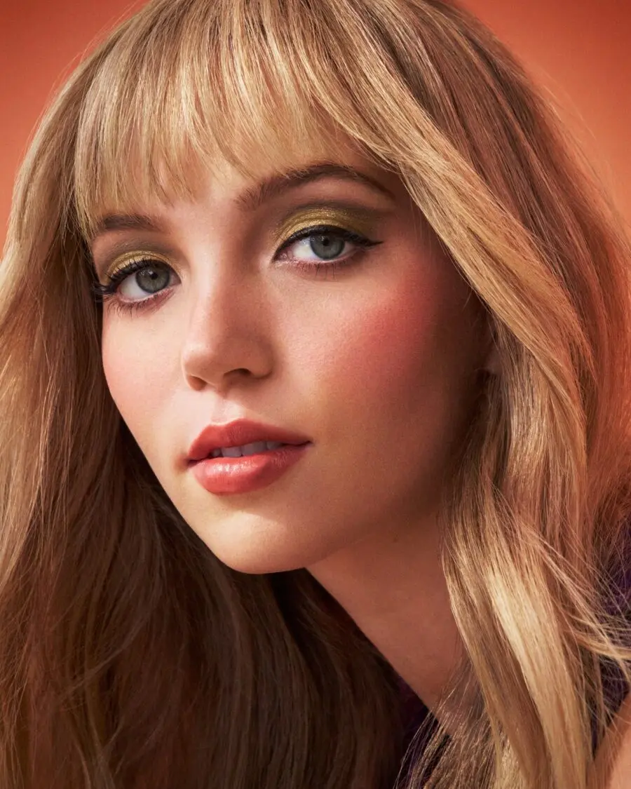 Golden eye makeup paired with soft peach blush