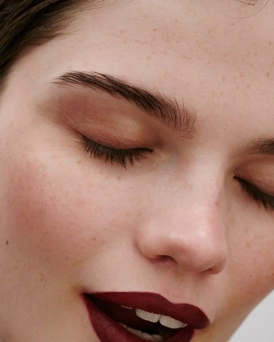 Flawless skin with bold burgundy lips