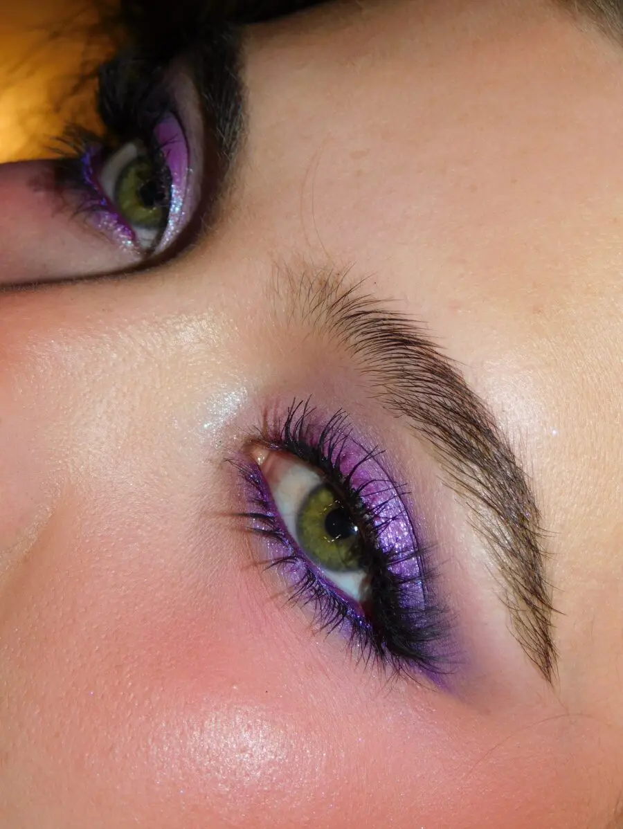 Vibrant purple eye makeup with glossy finish