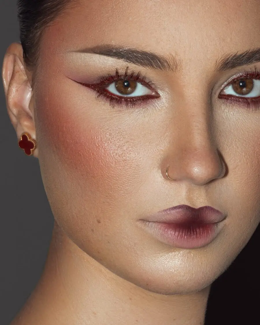 Bold red accents enhance smokey eye look