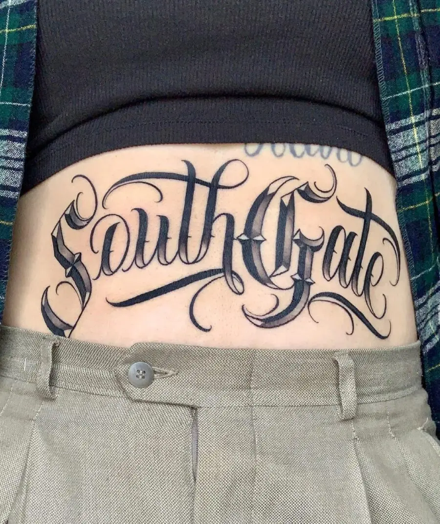 Elegant script tattoo on the stomach
