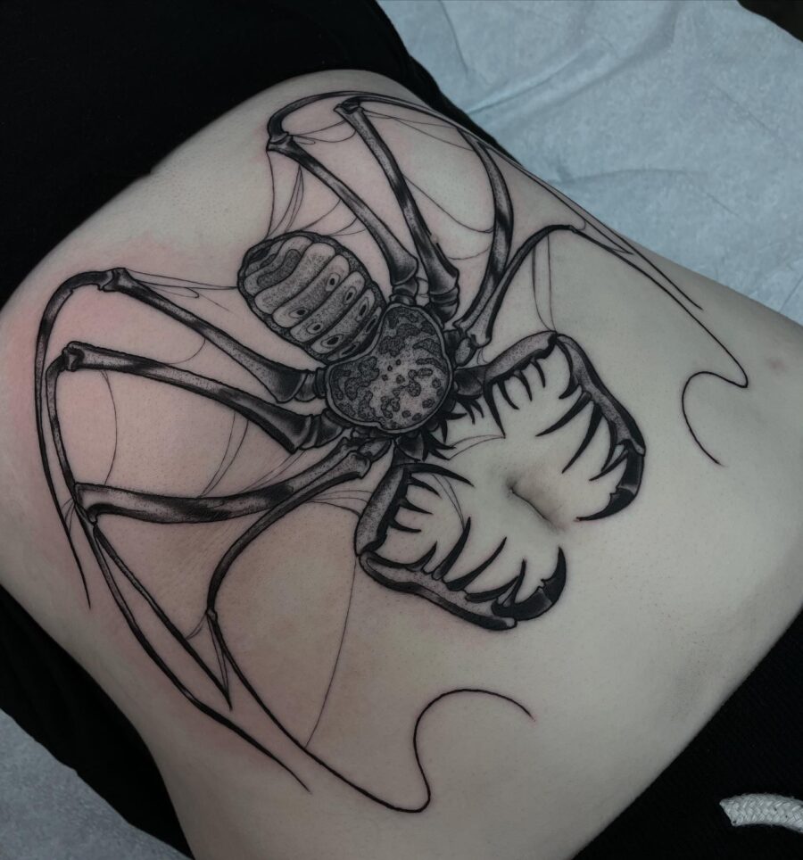 Intricate spider tattoo on the stomach