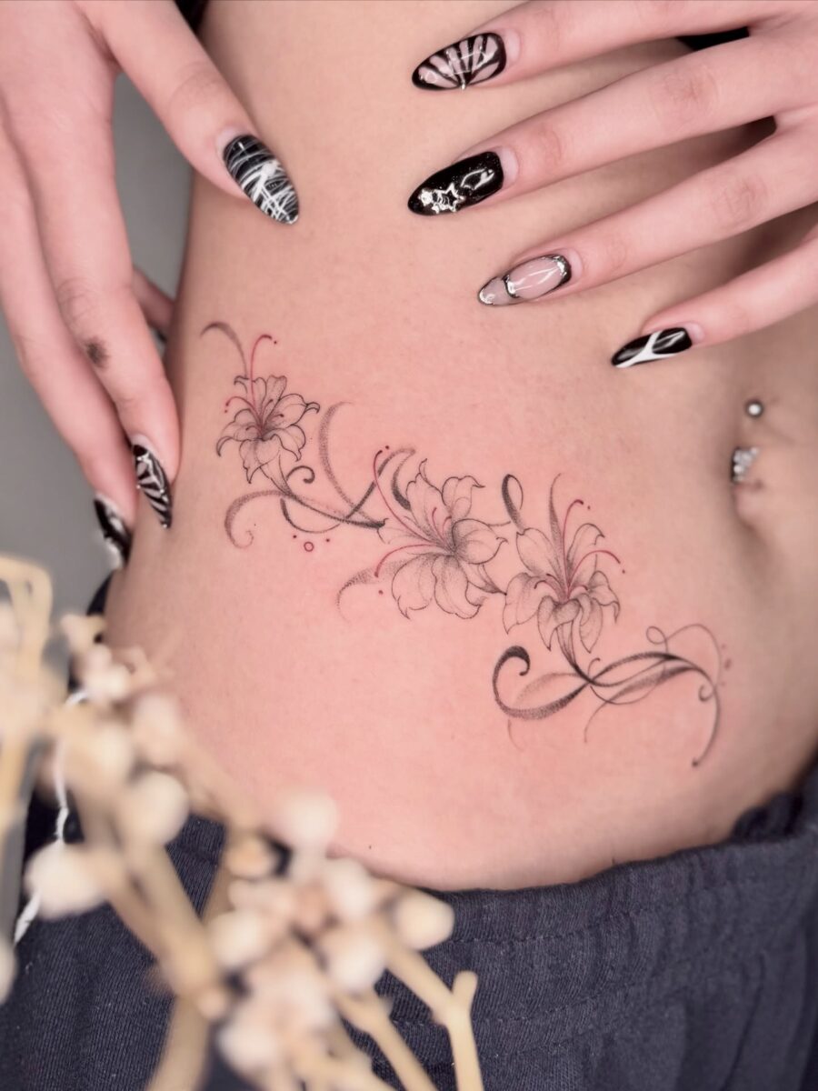 Delicate floral stomach tattoo design