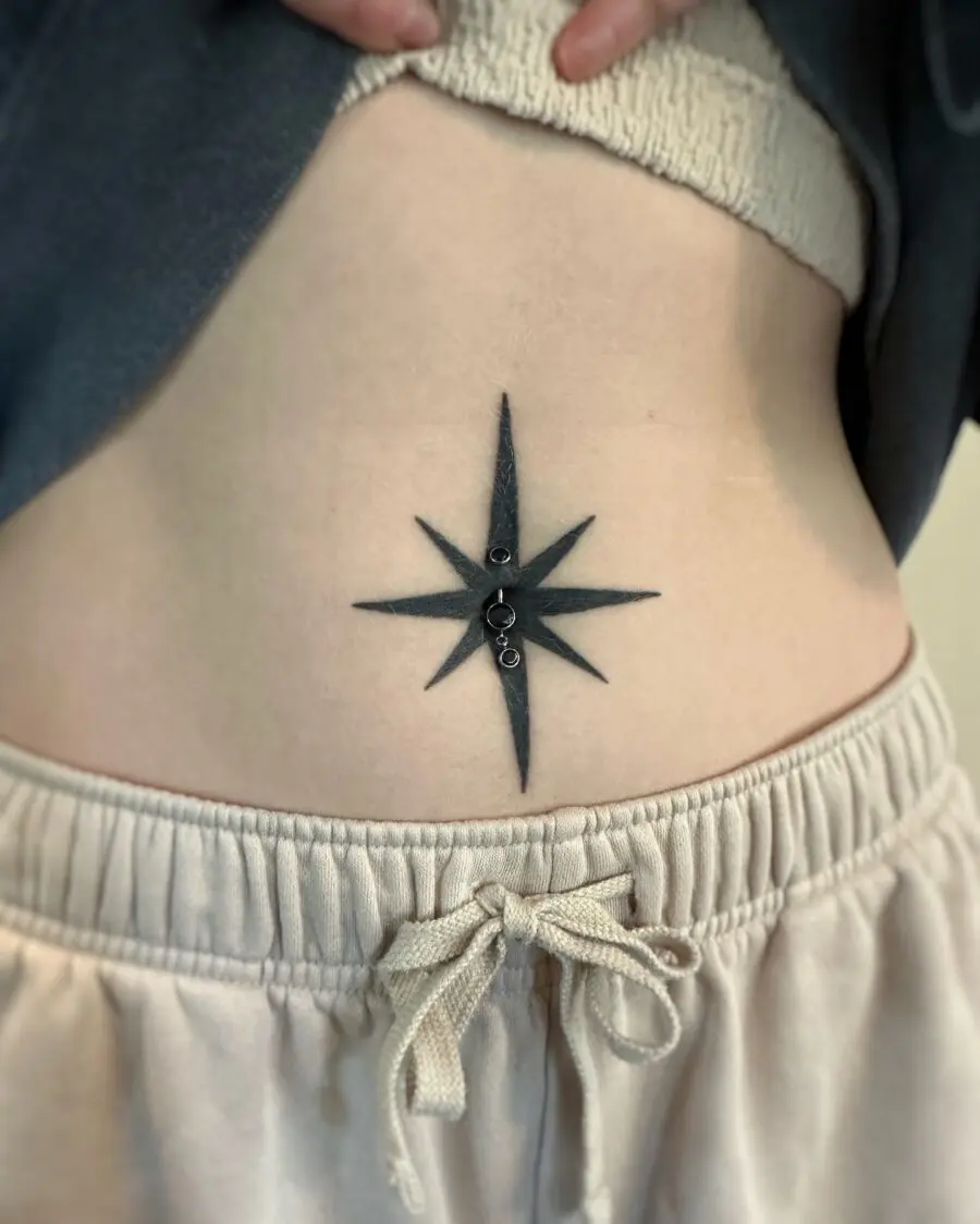 Bold star tattoo accentuating the stomach