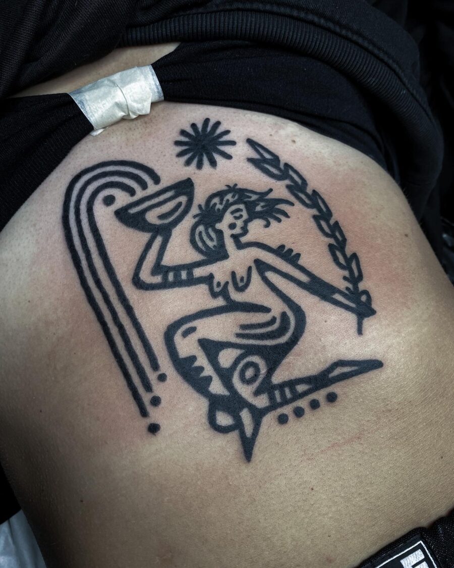 Abstract figure tattoo with vibrant symbolism