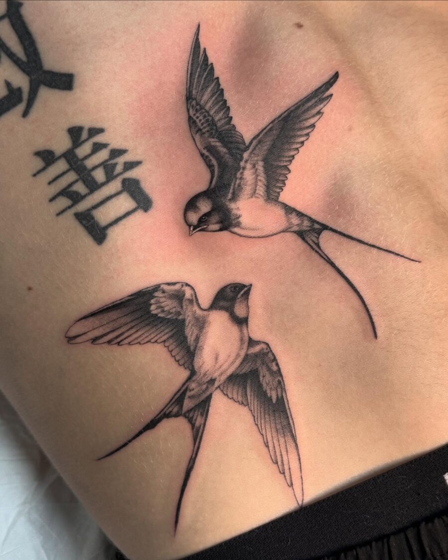Elegant birds in flight tattoo design