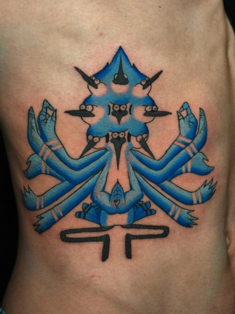 Intricate blue stomach tattoo design with symbolism