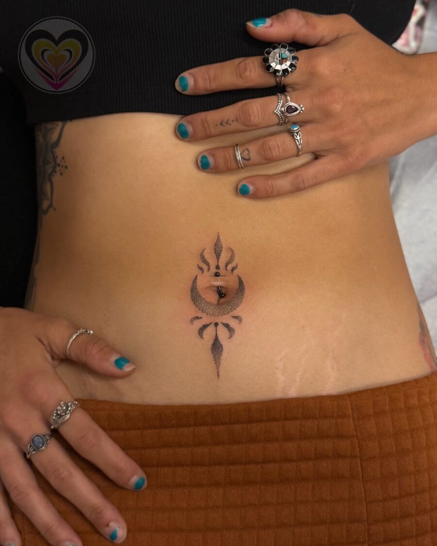 Elegant stomach tattoo design with spiritual flair