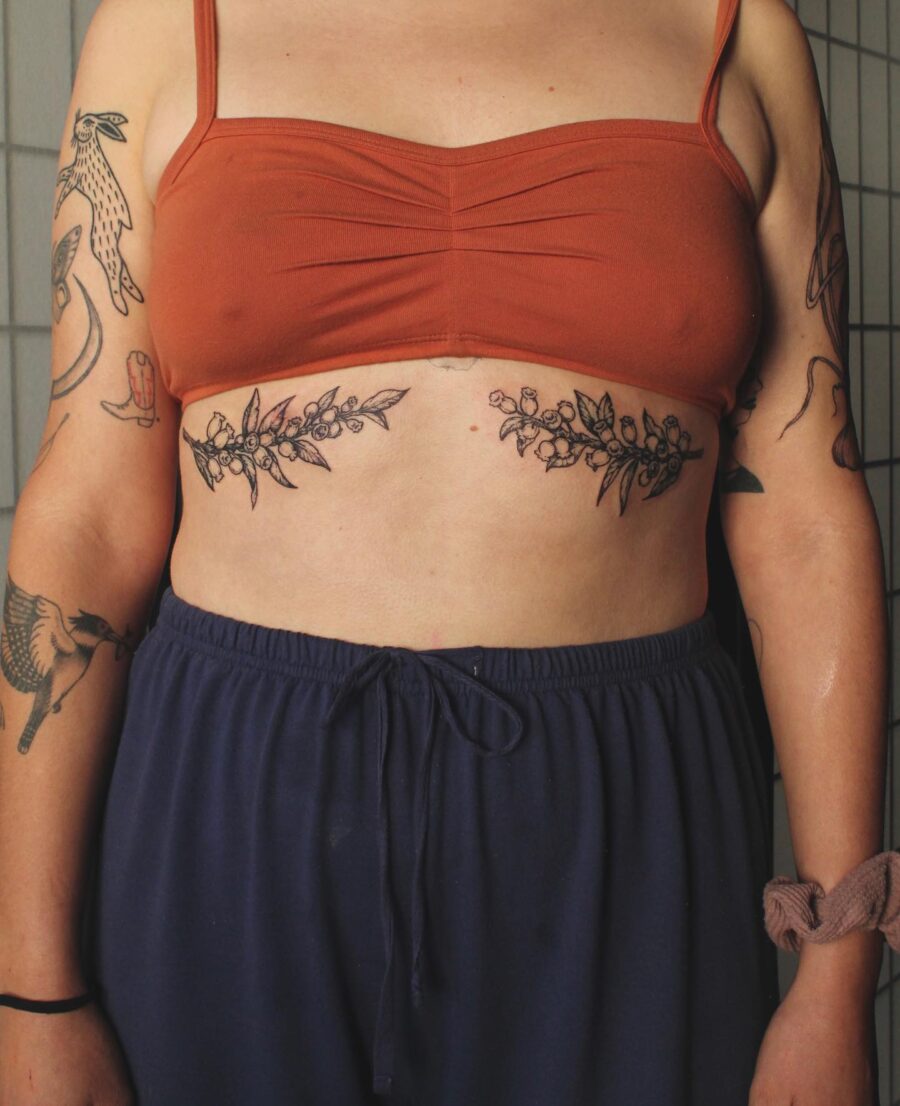 Elegant floral stomach tattoo highlighting body art