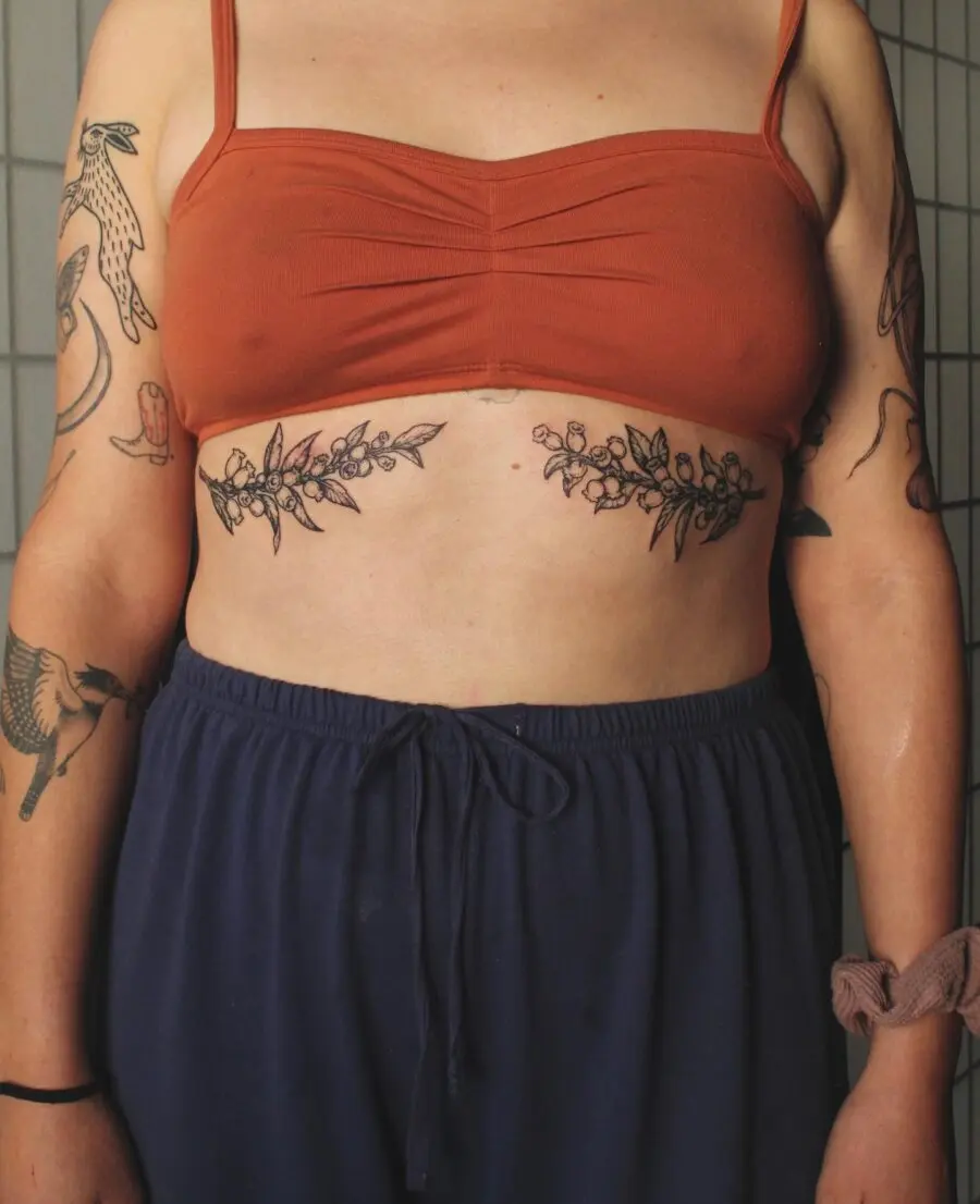 Elegant floral stomach tattoo highlighting body art