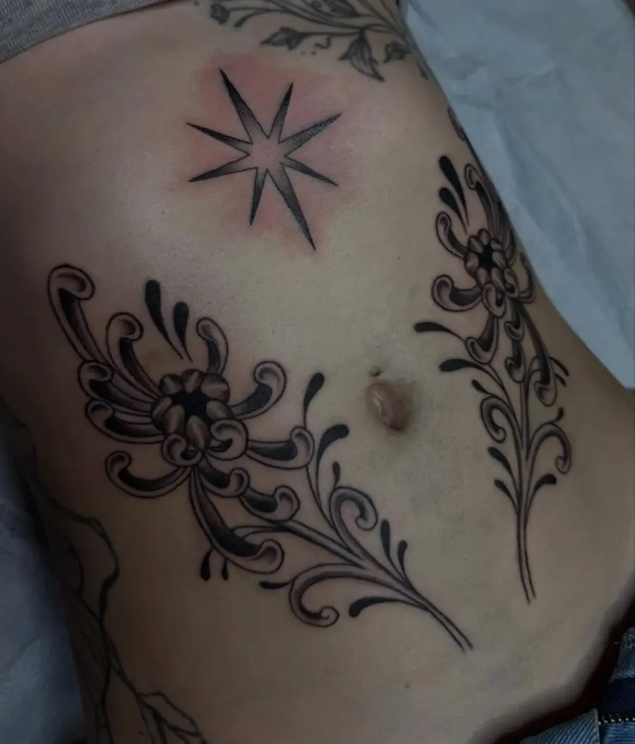 Elegant floral stomach tattoo with star detail