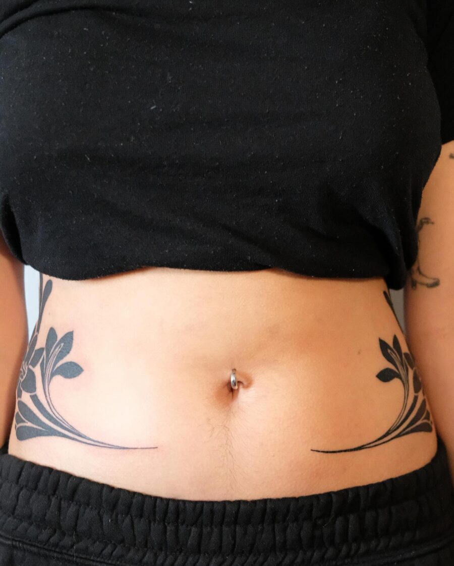 Elegant floral stomach tattoo design