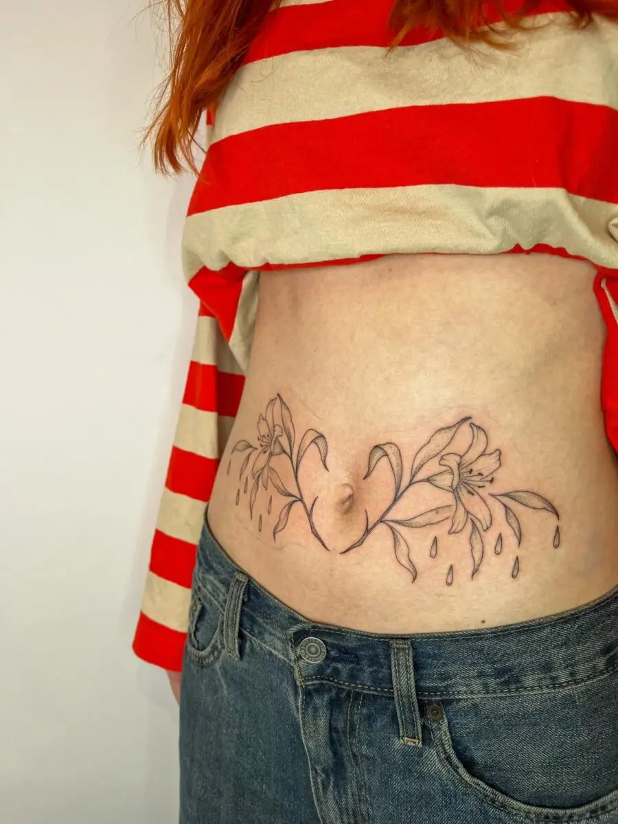Elegant floral stomach tattoo with a unique design