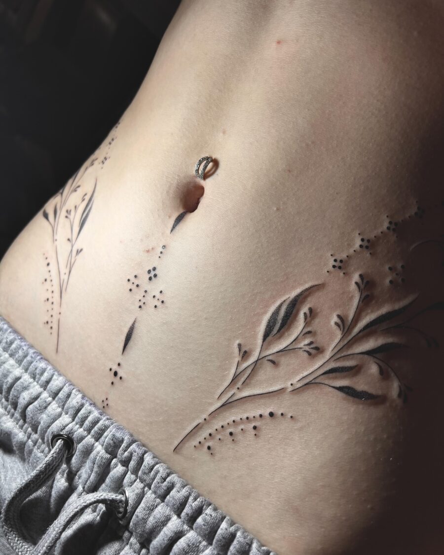 Elegant floral stomach tattoo design in black