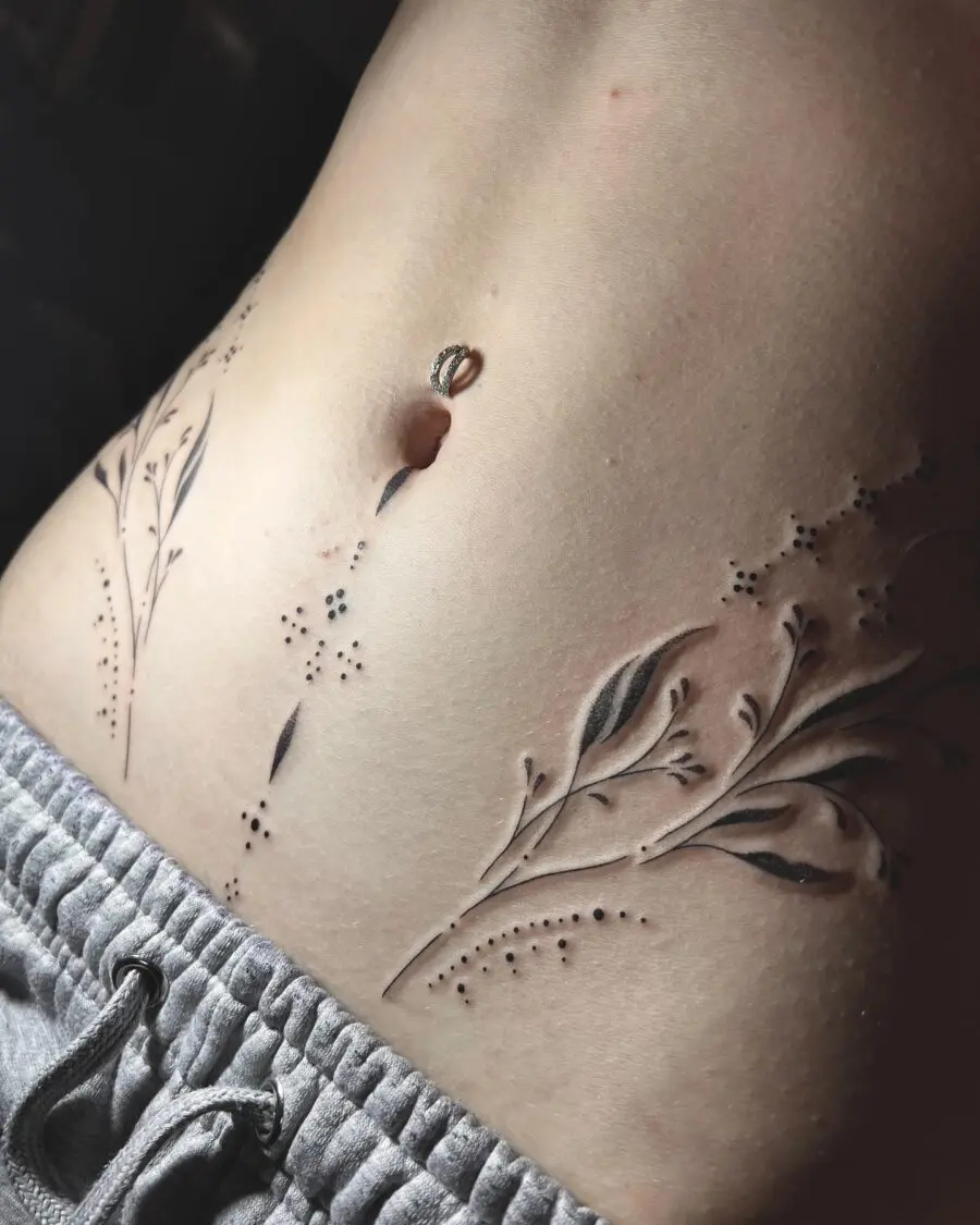Elegant floral stomach tattoo design in black