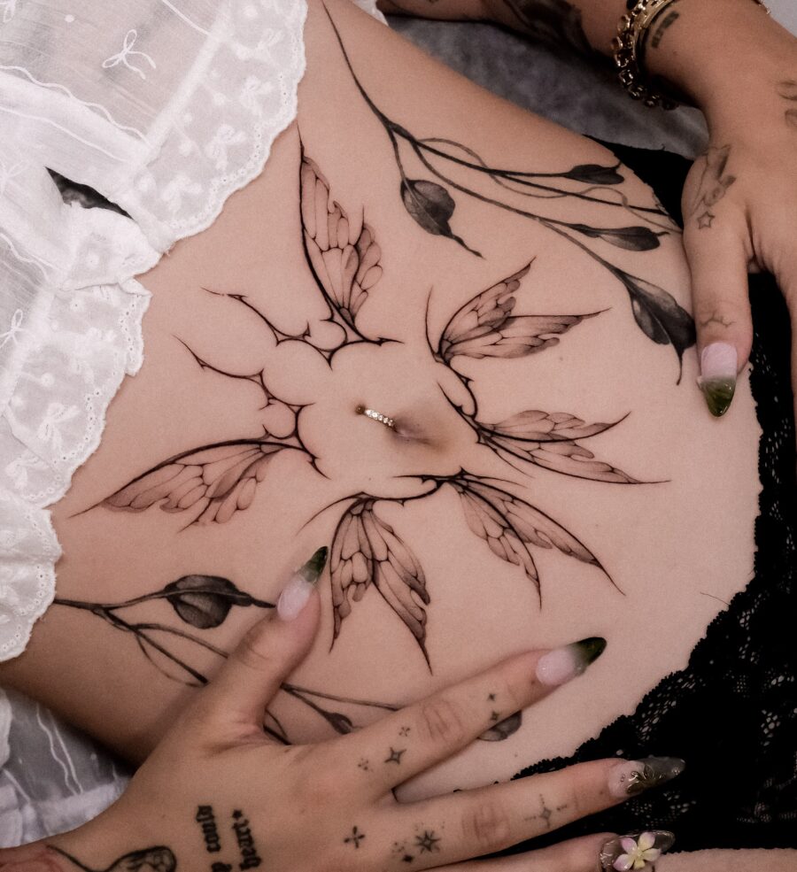 Elegant floral stomach tattoo with delicate details