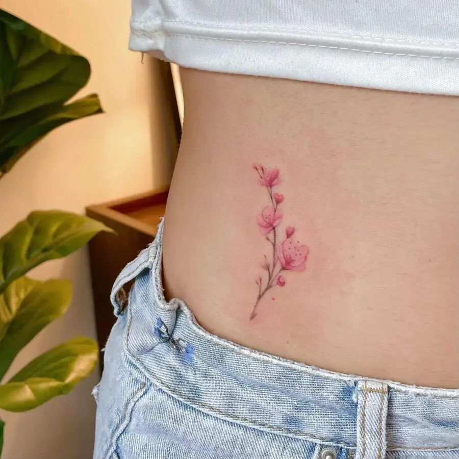 Delicate pink floral stomach tattoo design