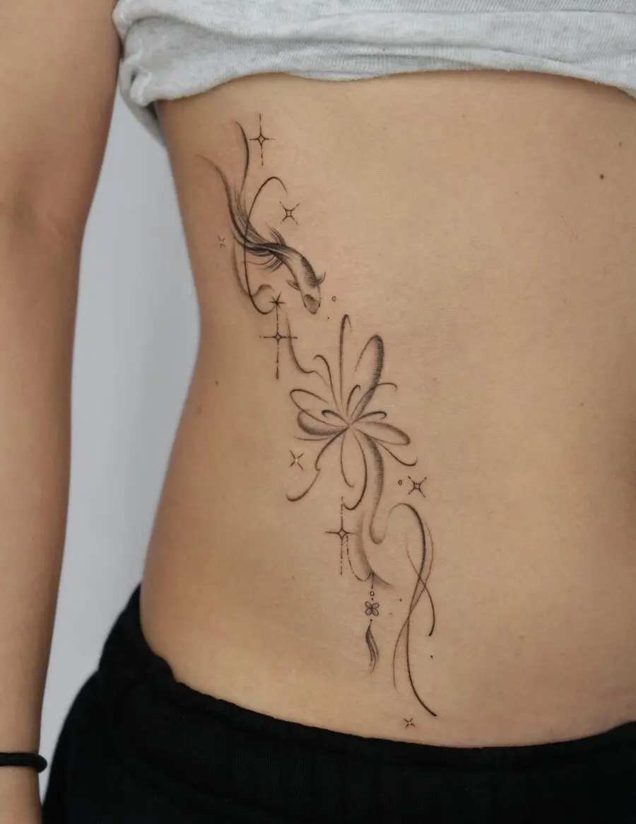 Elegant stomach tattoo with floral and star designs