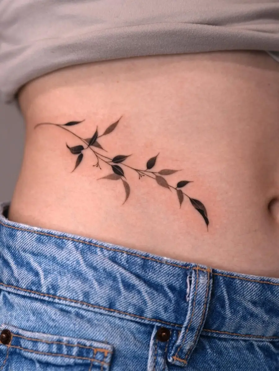 Elegant foliage stomach tattoo design