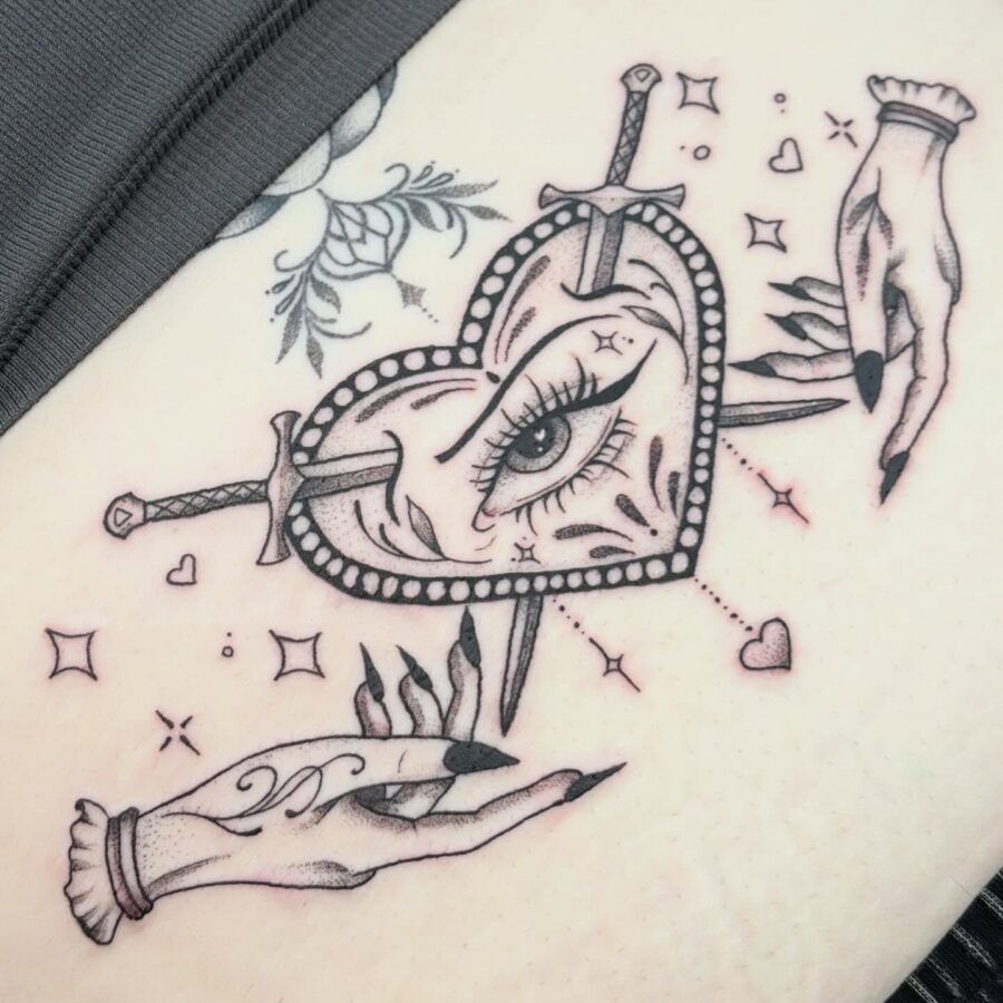 Intricate heart design with swords and hands