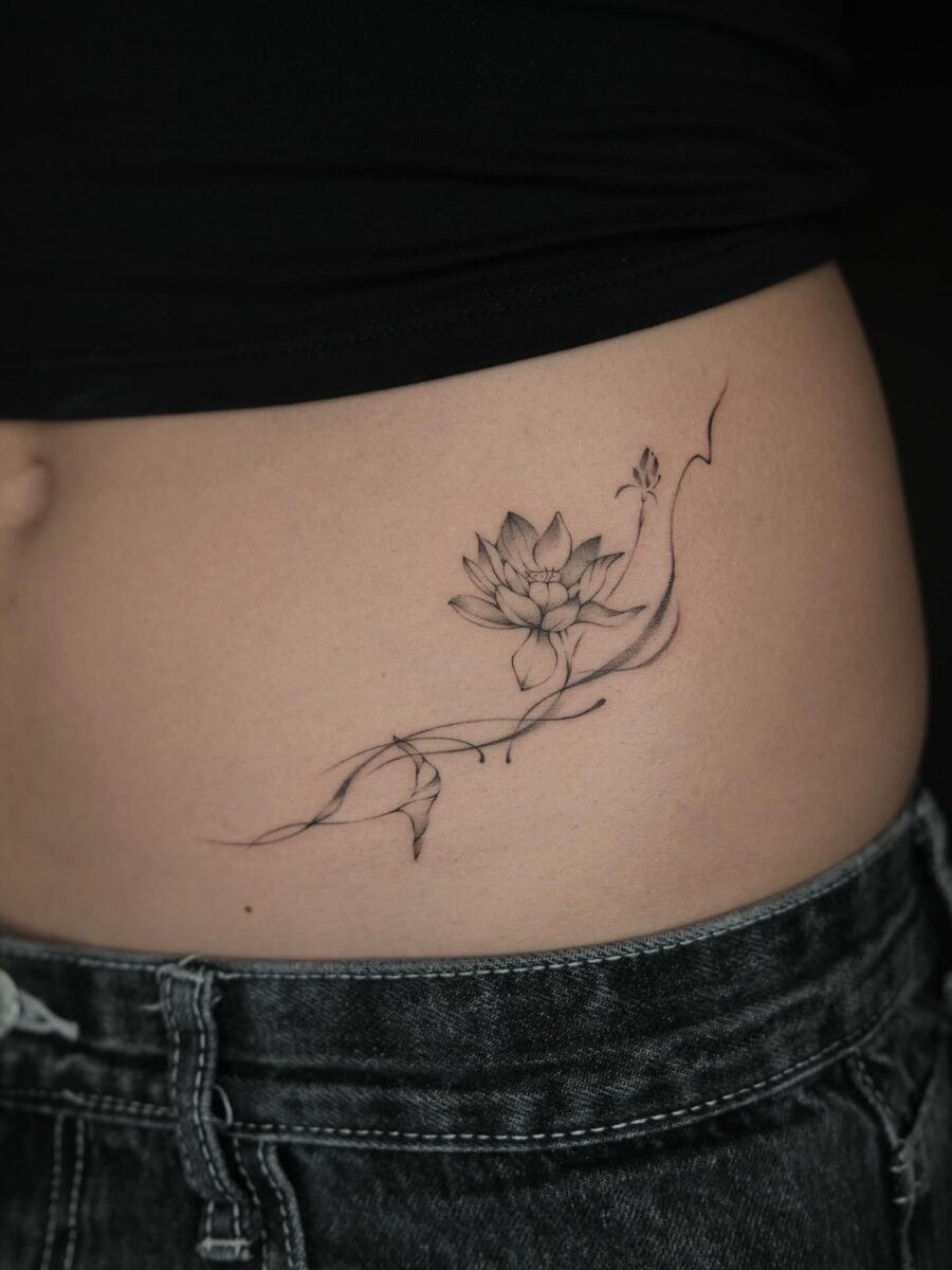 Elegant lotus flower stomach tattoo design