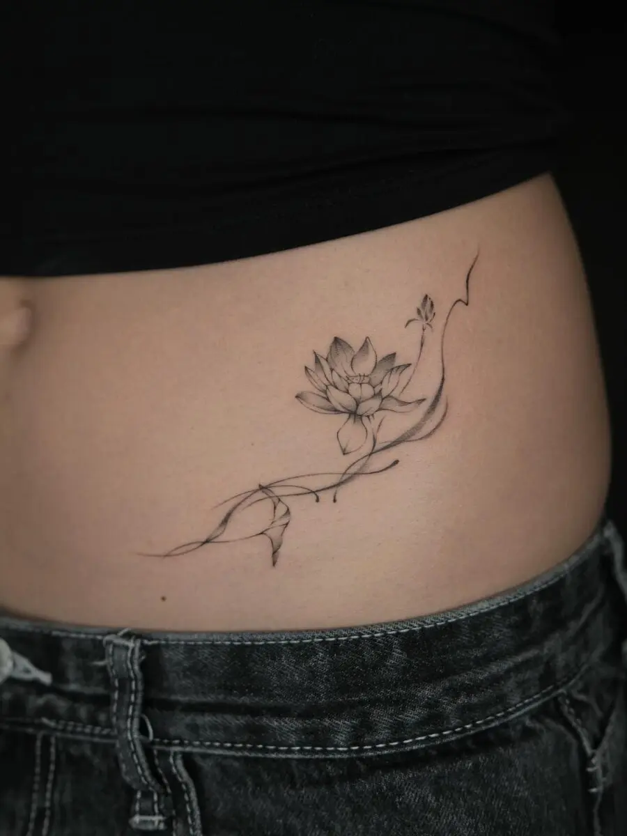 Elegant lotus flower stomach tattoo design