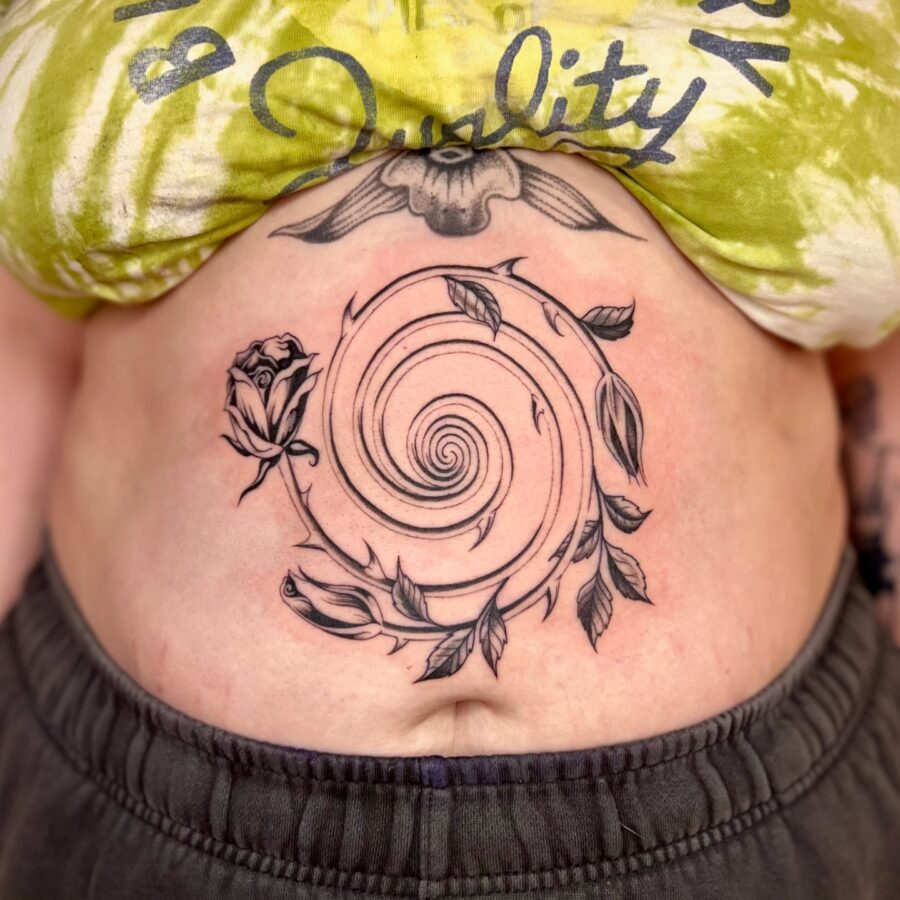 Artistic spiral tattoo with floral elements