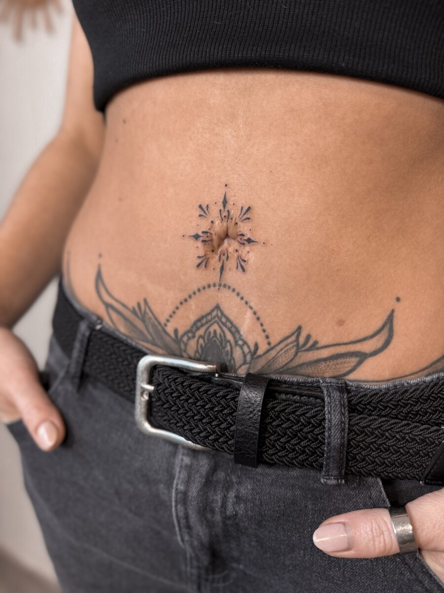 Intricate stomach tattoo showcasing floral elements