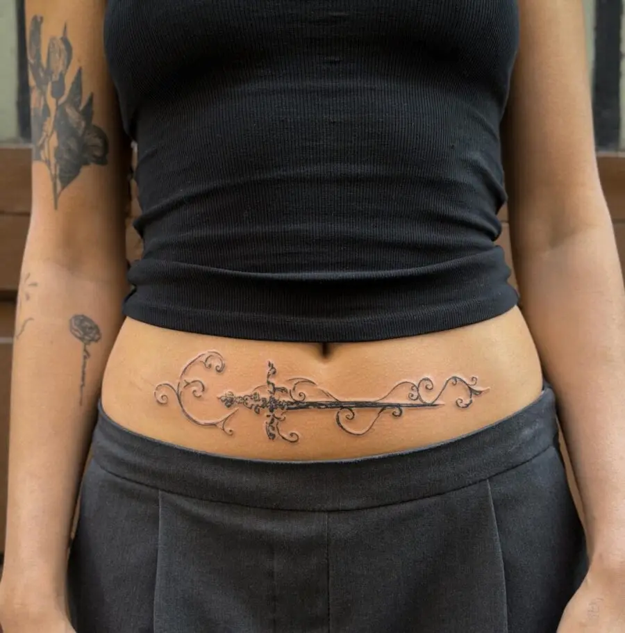 Elegant sword tattoo with floral accents