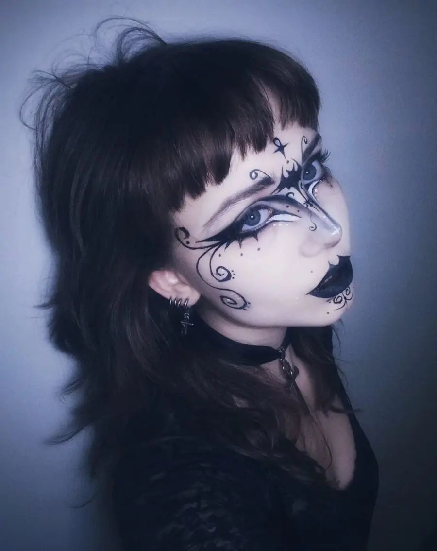 Intricate black and white goth makeup design