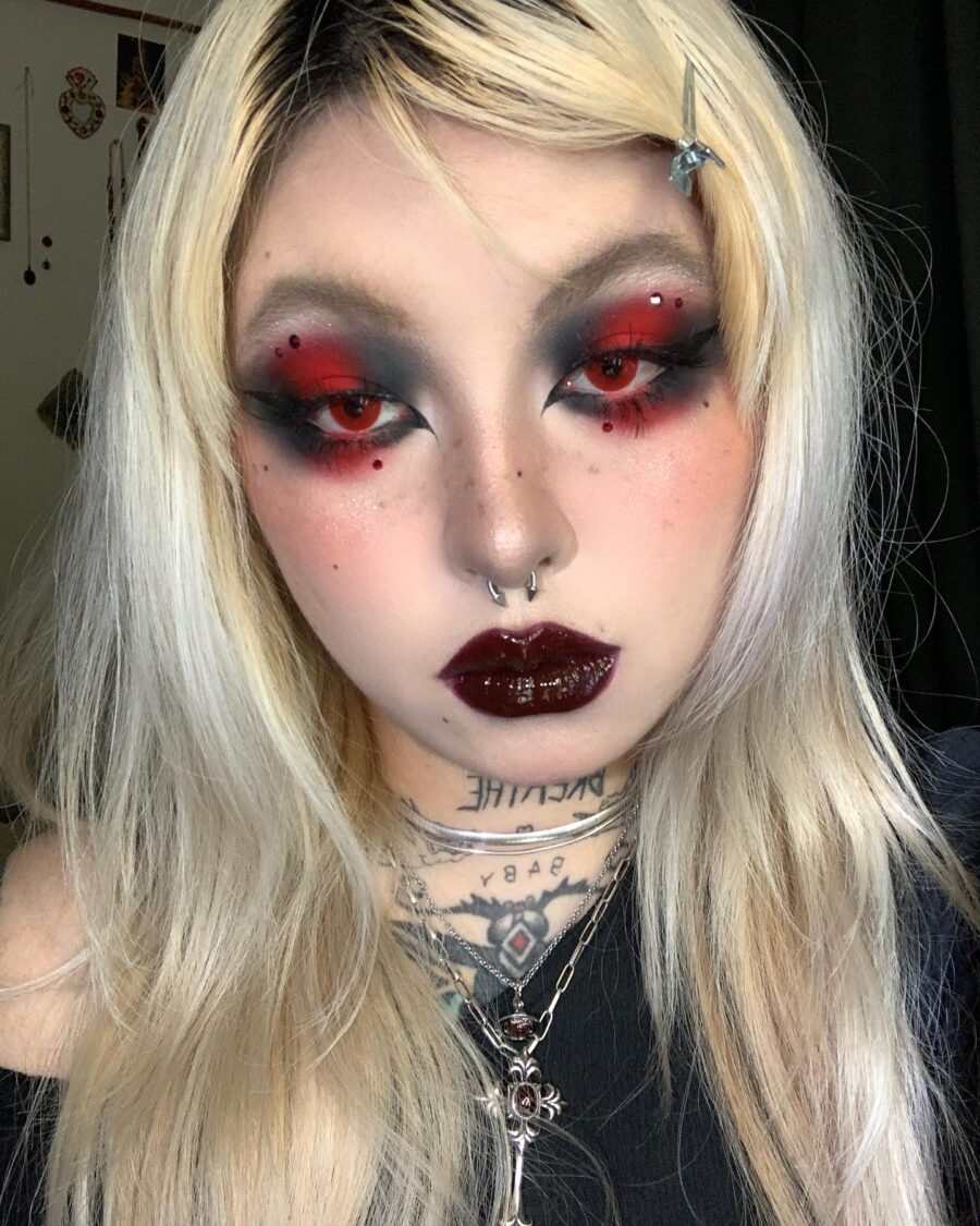 Bold red and black trad goth makeup look