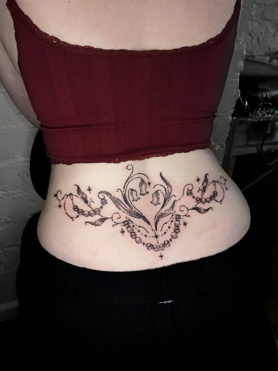 Elegant floral tramp stamp tattoo design