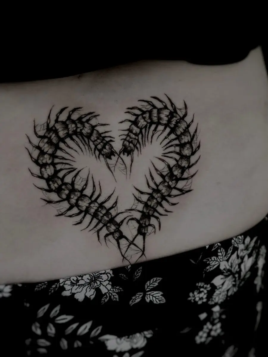 Intricate scorpion heart tattoo on lower back