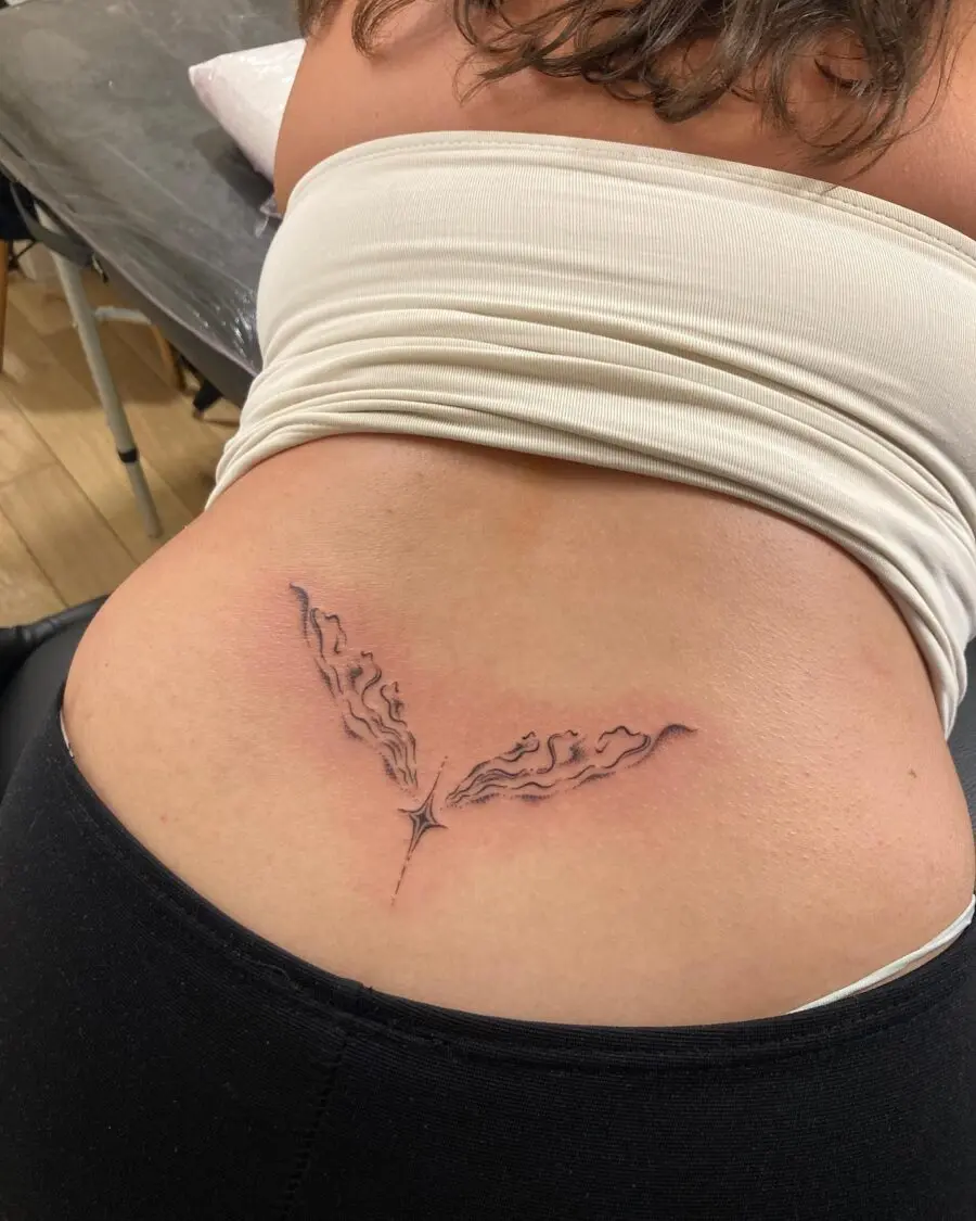 Elegant flame design tramp stamp tattoo