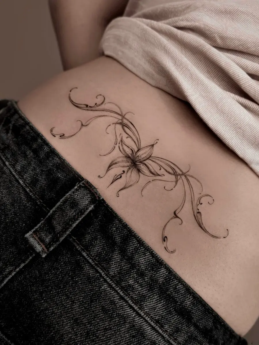 Elegant floral tramp stamp tattoo design