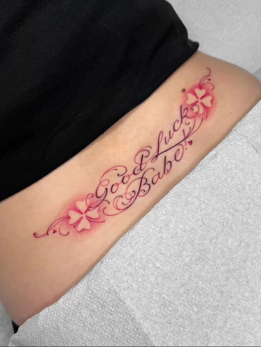 Delicate flower-script tramp stamp design