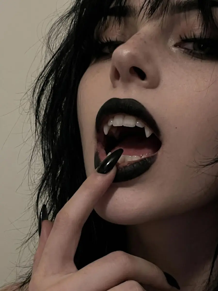 Striking vampire makeup with bold black lips