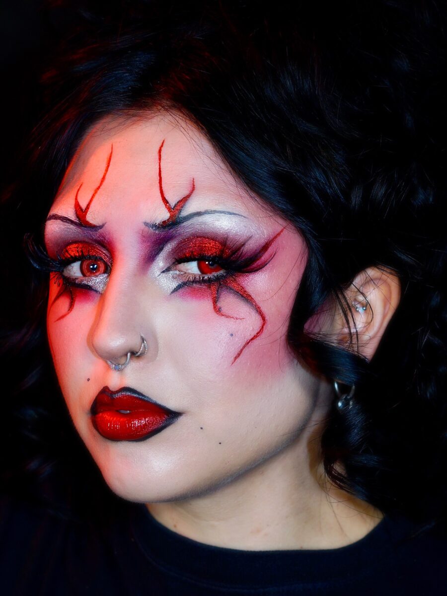 Striking vampiric makeup with red accents