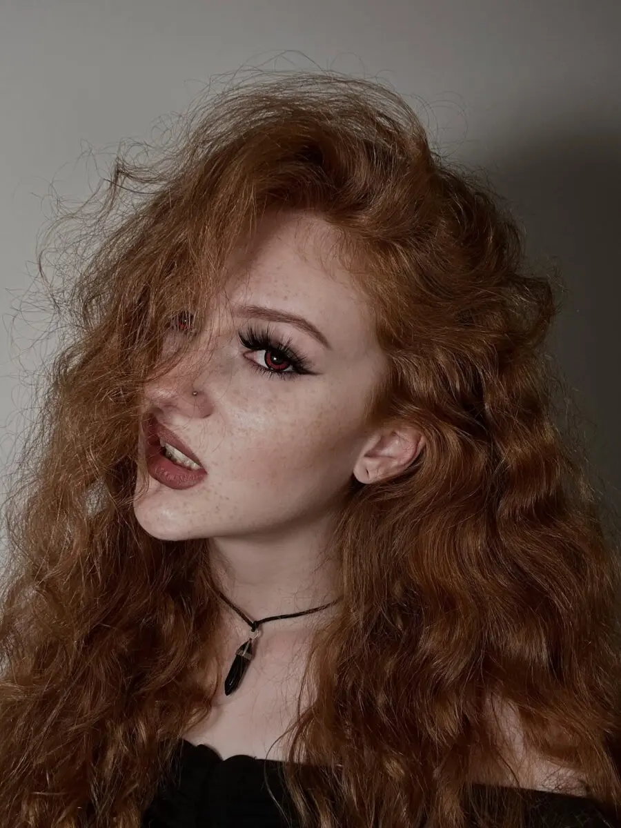 Dramatic vampire look with fiery red curls