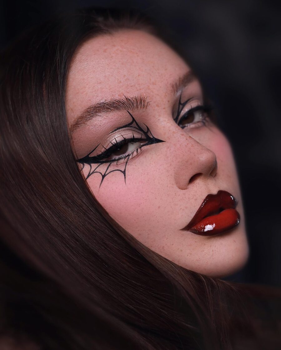 Striking vampire makeup with a spider web design