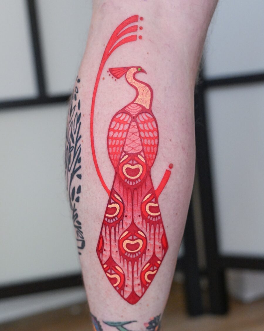 Striking red ink peacock tattoo design