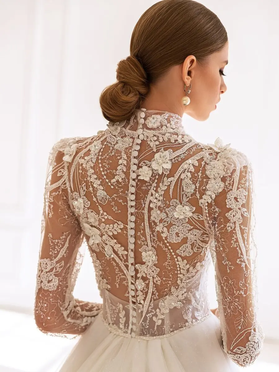 Elegant wedding dress with intricate lace sleeves.