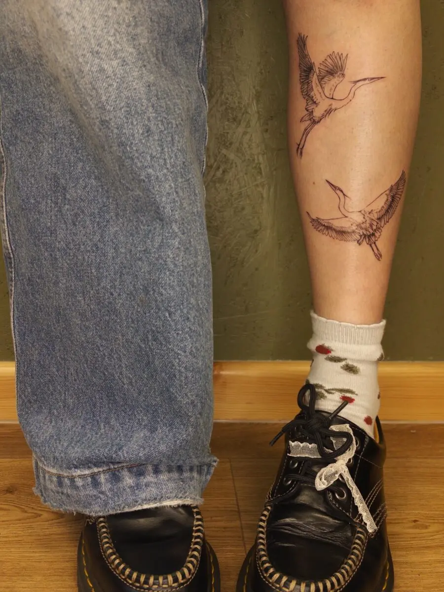 Bird tattoos add a whimsical flair to legs