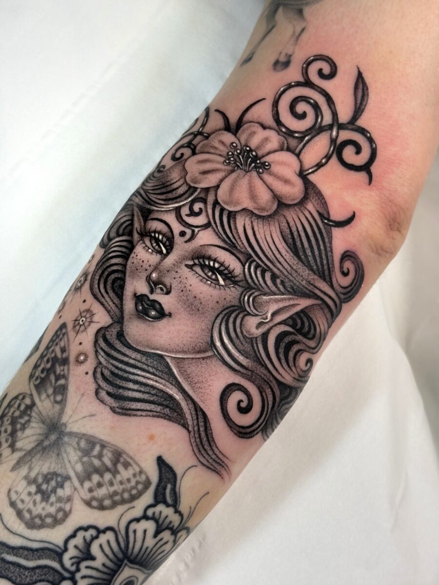 Enchanting whimsical fairy tattoo on forearm