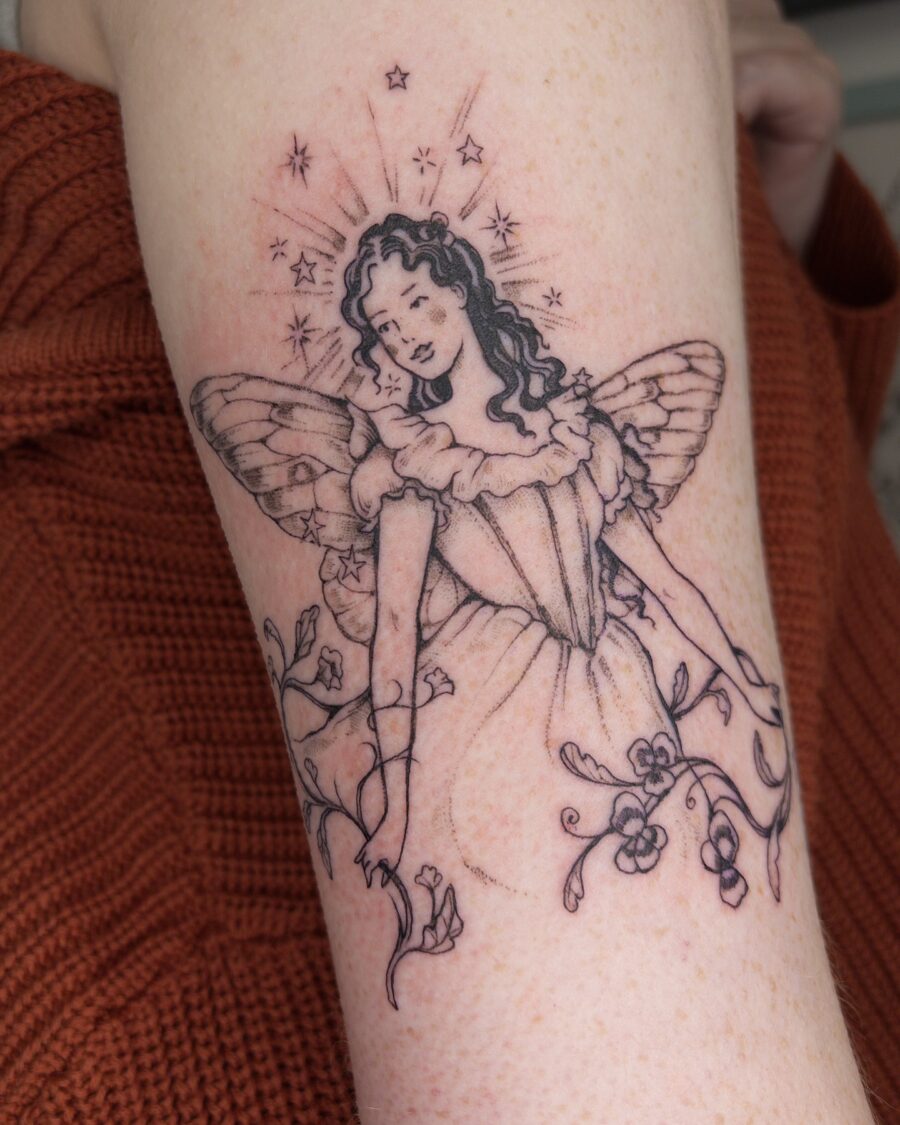 Delicate fairy tattoo radiating whimsical charm
