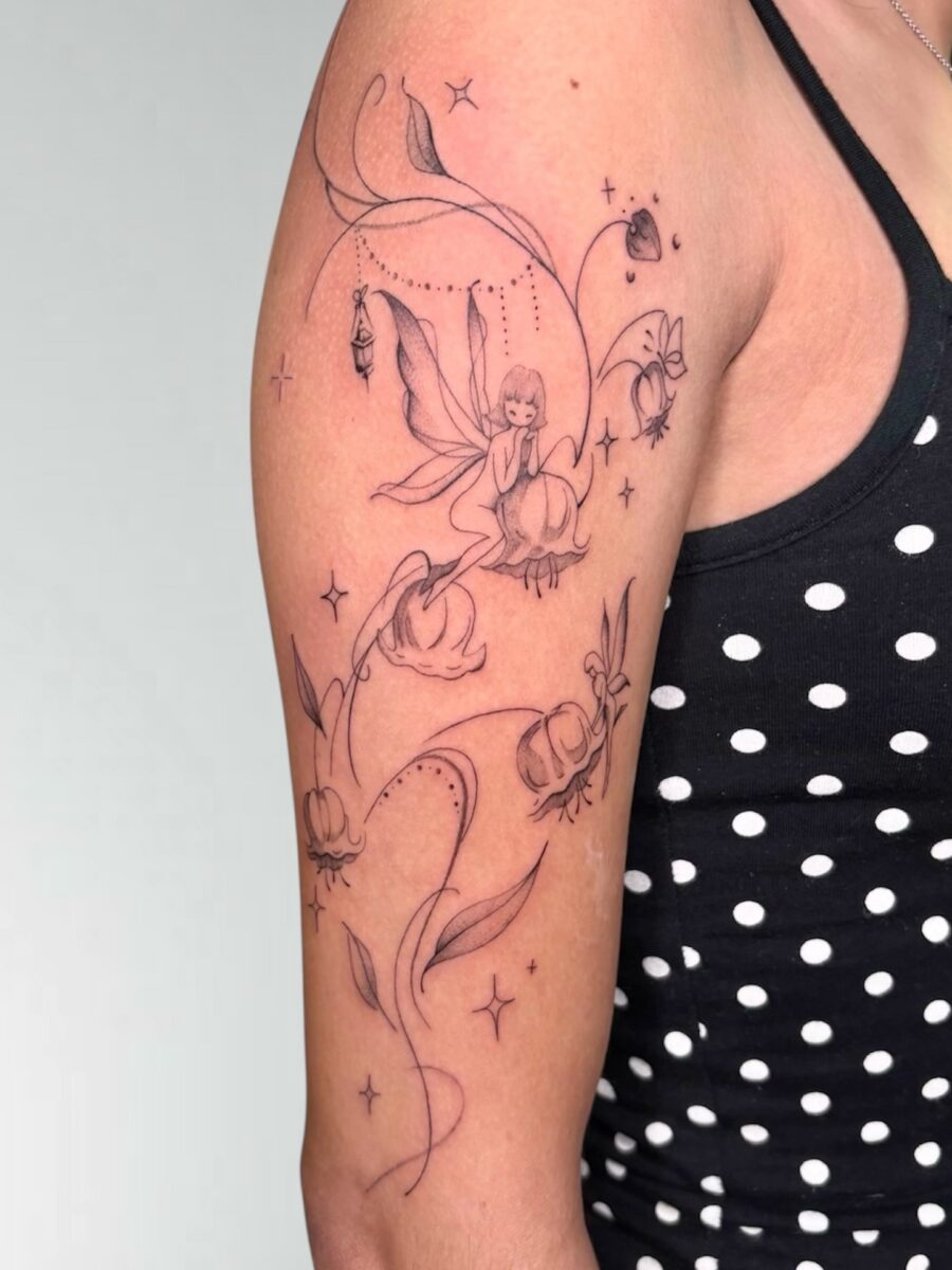 Charming fairy amid blooming flowers tattoo