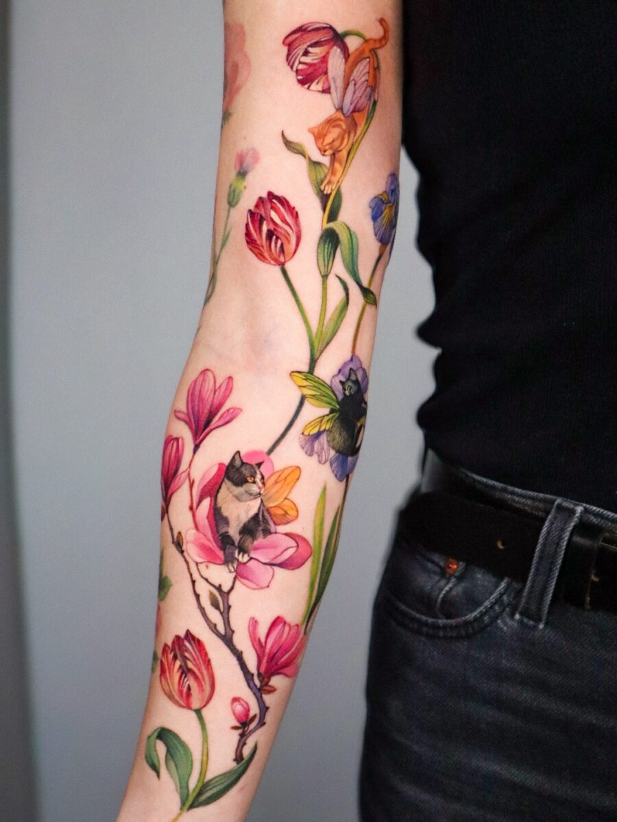 Vibrant floral tattoo with enchanting bird elements